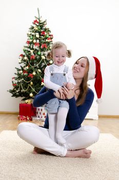Little girl and her mom having fun at Christmas