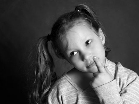 Portrait of the thoughtful girl of 5 years in studio