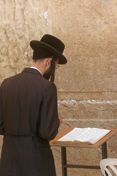 Orthodox man prayers at Western wall of Jerusalem