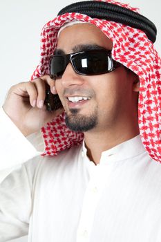 Young successful arab talking over cell phone and smiling