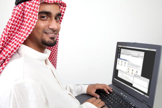 An arab person working on laptop