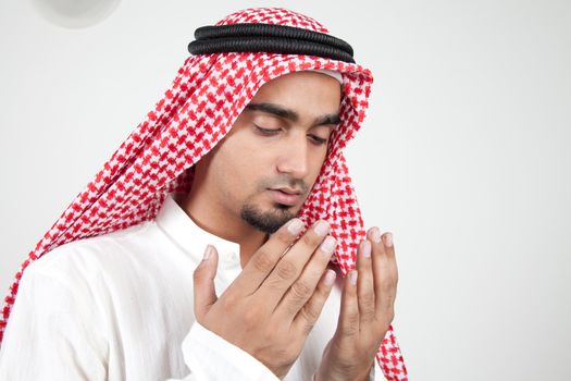 Young arab muslim praying 