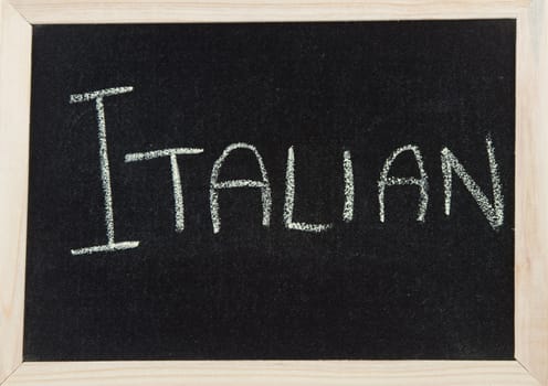 A black board with a wooden frame and the word 'ITALIAN' written in chalk.