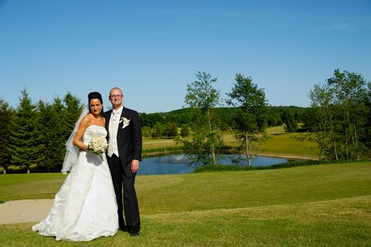 Bride and groom togeter in green nature