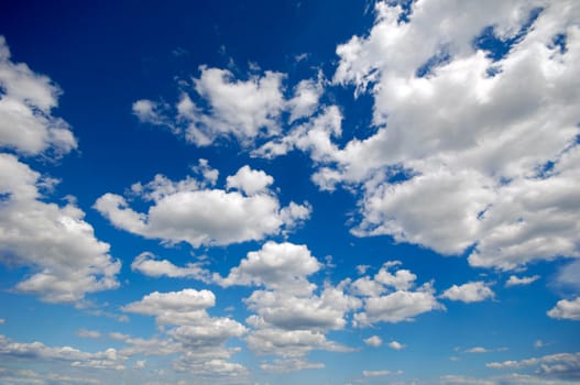 White clumulus clouds and a blue sky