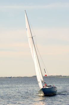 A boat is sailing at the sea.