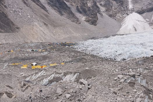 Everest Base Camp. Cluster of yellow tents on the rubble strewn Khumbu glacier at the base of Mount Everest, Nepal