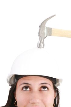 girl with safety helmet about to be hit by a hammer over a white background