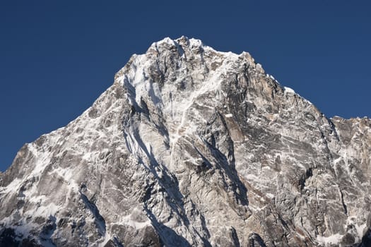 Snow covered mountain peak (Arakam Tse - 6423m) high in the Himalaya Mountains of Nepal