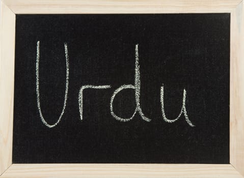 A black board with a wooden frame and the word 'URDU' written in chalk.