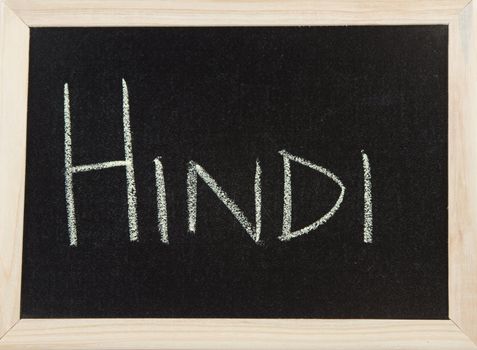 A black board with a wooden frame and the word 'HINDI' written in chalk.