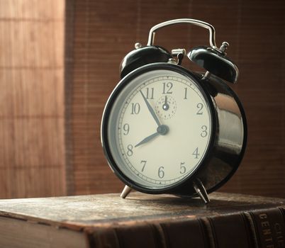 Sunday morning, shot retro alarm clock, closeup. Natural morning light setup.