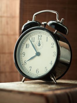 Sunday morning, shot retro alarm clock, closeup. Natural morning light setup.