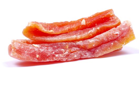 orange dried papaya slices over white background