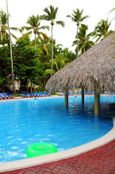 Swimming pool with swim up bar at tropical resort