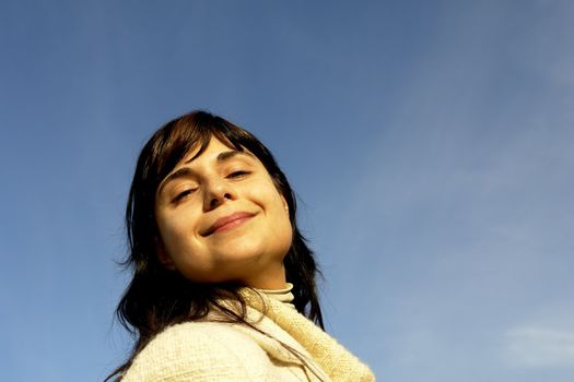 young woman close up portrait enjoying the sun