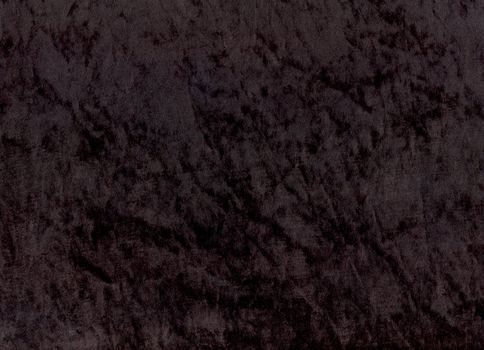 A sample of black shimmery velours fabric - an exclusive and trendy background.