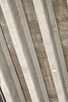 Underside of a highway bridge, forming abstract concrete stripes.
