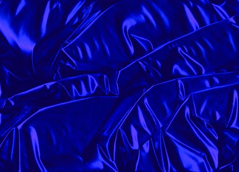 An exclusive background of shiny royal blue decoration fabric with a metallic surface.
