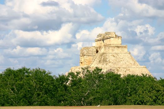 Main pyramid on mayan sute Uxmal over blue sky