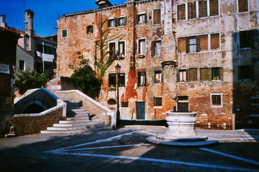 Venetian campo with ancient house and well
