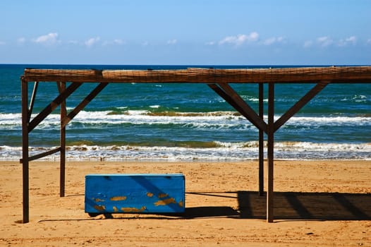 Abandonate blue box  on beach 