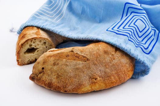 Bread loaf and blue cotton bag on white background