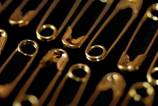 Extreme close up of gold safety pins