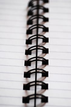 A spiral bound notepad close-up with lined paper