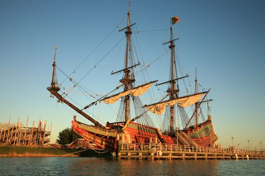 Batavia – historic galleon from Netherlands by sunset. Old ship. Lelystad, Flevoland.