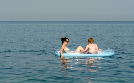The woman and the child on an inflatable boat in the sea