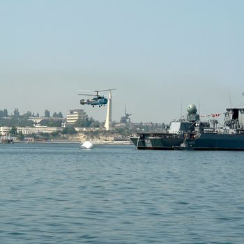 Large helicopter lands aboard the warship