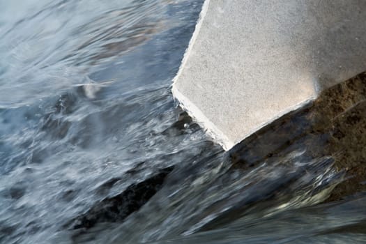 Floating of ice on the river. Small waterfall. Ice floe now will fall.