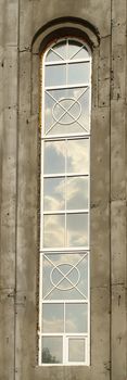 Cloud sky is reflected in the long narrow window