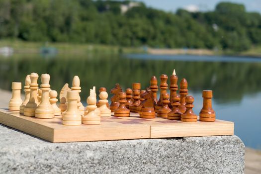 the chessboard with the figures with river at background