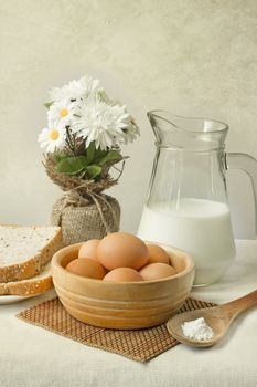 eggs bread and milk on the table
