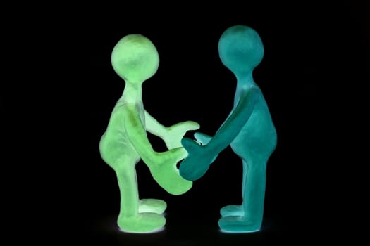 Two shaded plasticine puppets standing opposite each other