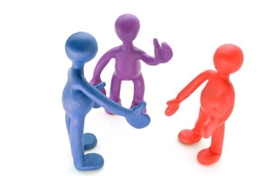 Three colored plasticine puppets talking on white background