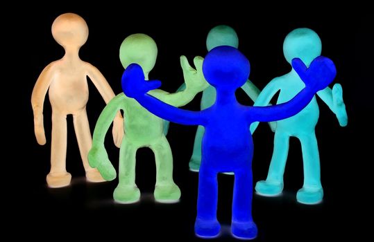 Shaded group of plasticine puppets on black background