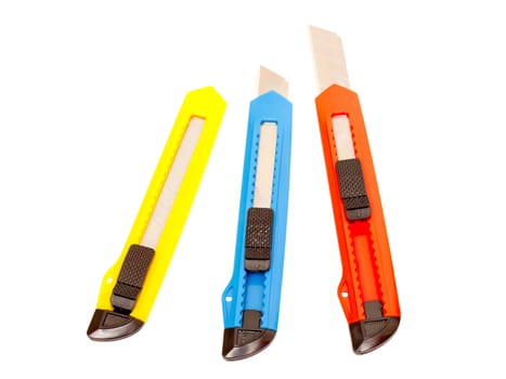 three multi-colored stationery knife on a white background