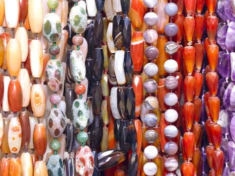 multi-colored beads of various sizes and shapes on the wall