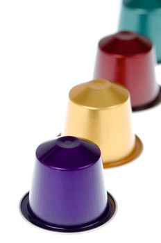 Coffee capsules for a coffee machine, close up view isolated on white background.