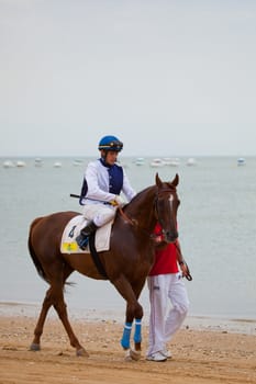 SANLUCAR DE BARRAMEDA, CADIZ, SPAIN - AUGUST 07: Unknown rider at the start of the horses races of the beach of Sanlucar de Barrameda on August 07, 2010 in Sanlucar de Barrameda, Cadiz, Spain.