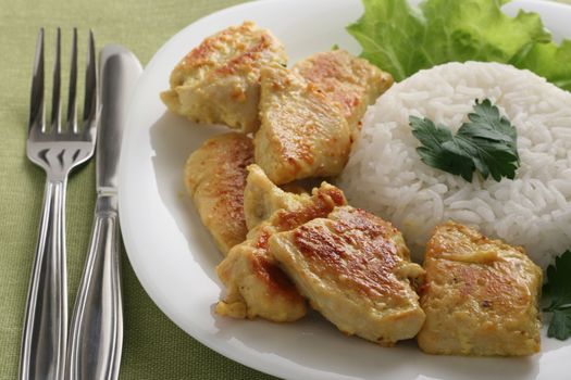 fried chicken with rice on an white plate