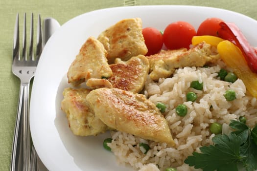 fried chicken with rice on an white plate