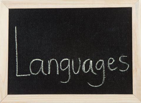 A black board with a wooden frame and the word 'LANGUAGES' written in chalk.