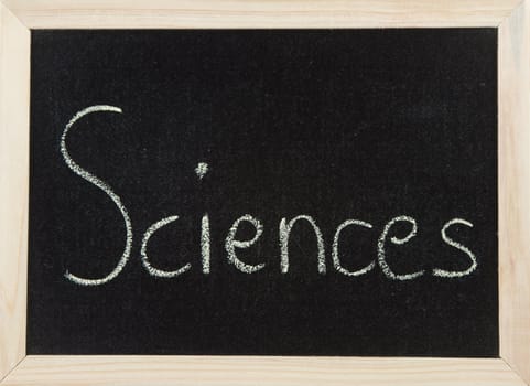 A black board with a wooden frame and the word 'SCIENCES' written in chalk.