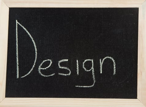 A black board with a wooden frame and the word 'DESIGN' written in chalk.