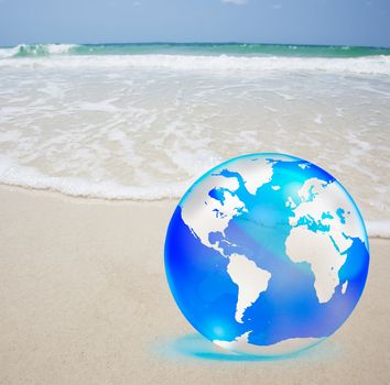 crystal globe over sand and  sea