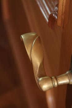 Close up of a door knob on a wooden door.